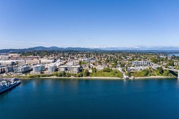 A cityscape with a large body of water and a boat docked at the pier  at Spyglass Hill Apartments, Bremerton, 98337